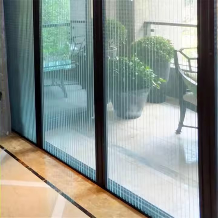 Close-up of the retractable pleated screen mesh and frame on a sliding balcony door